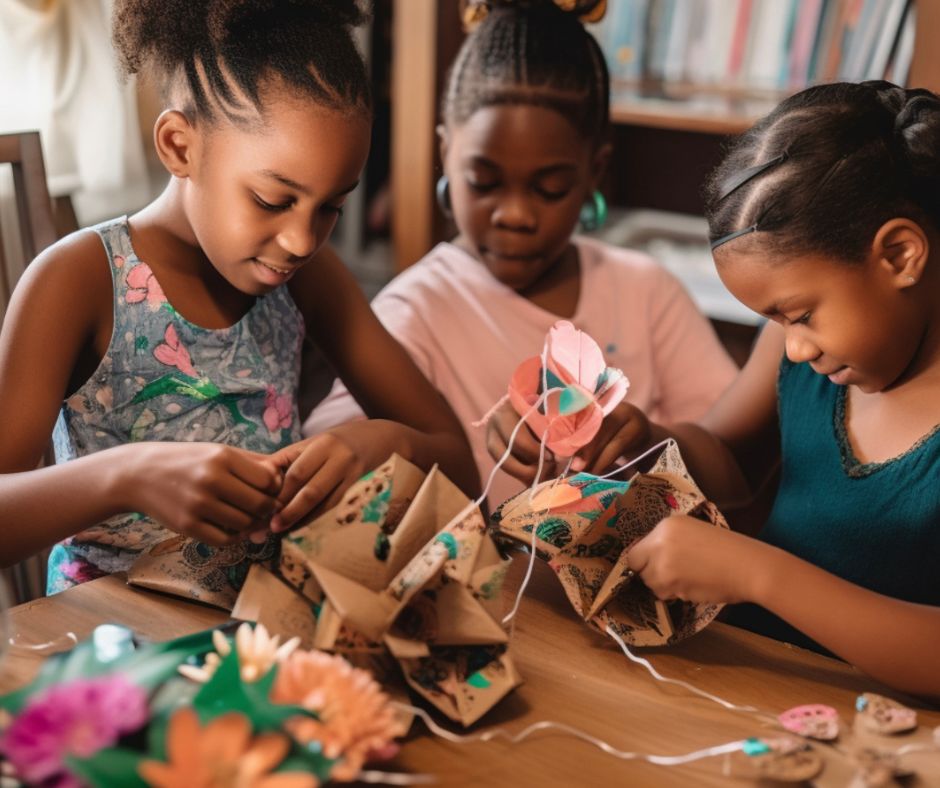 Three girls making crafting Mother's Day gifts together on a table.